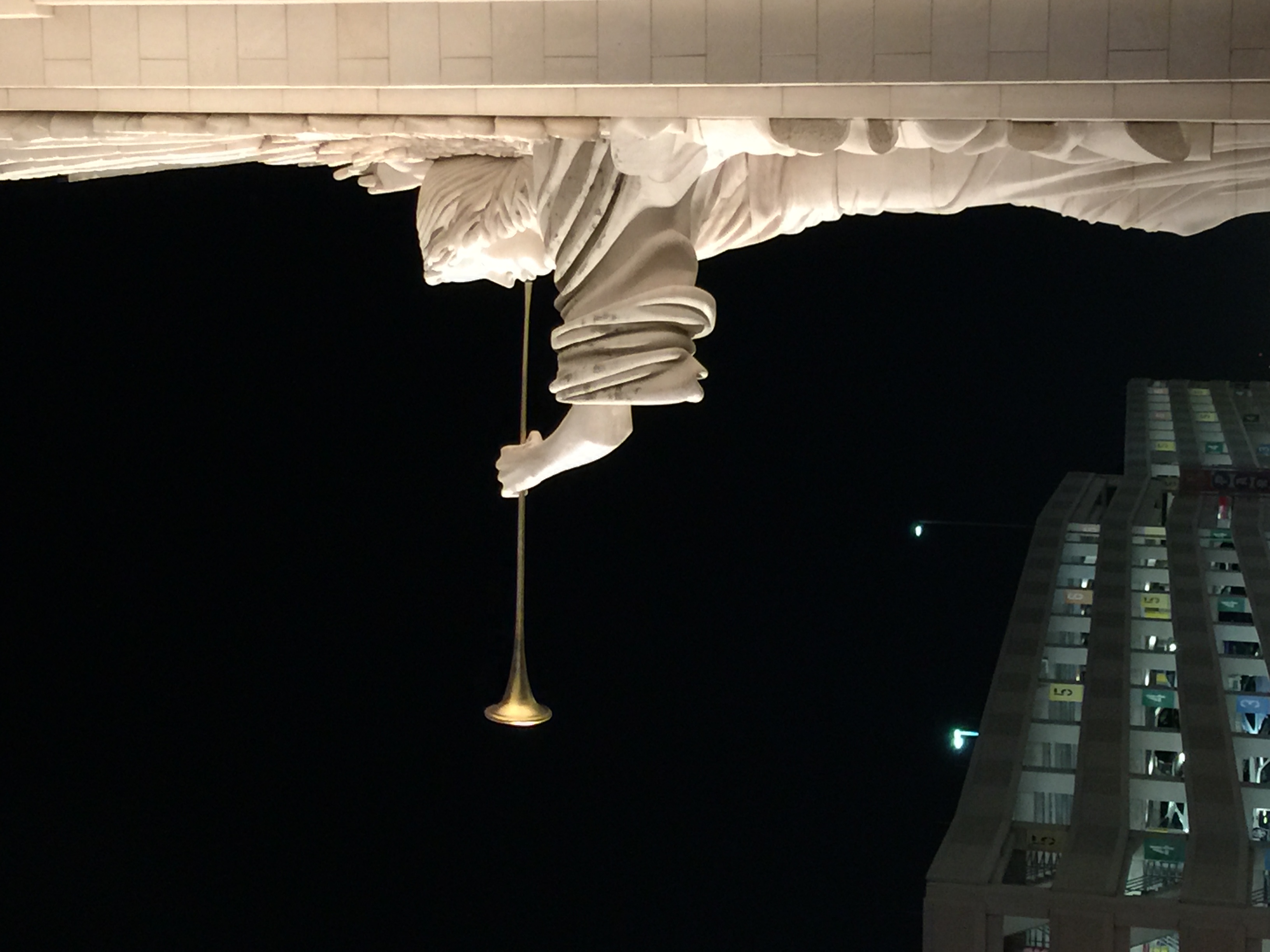Architectural canopy and hanging light photographed at night